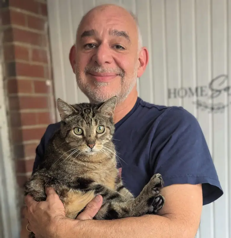 Mitch holding Leonardo at home on porch