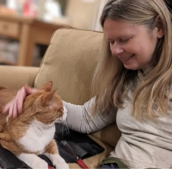 Cat sitter Raisa spending quiet, gentle time with a cat during an in-home cat sitting visit
