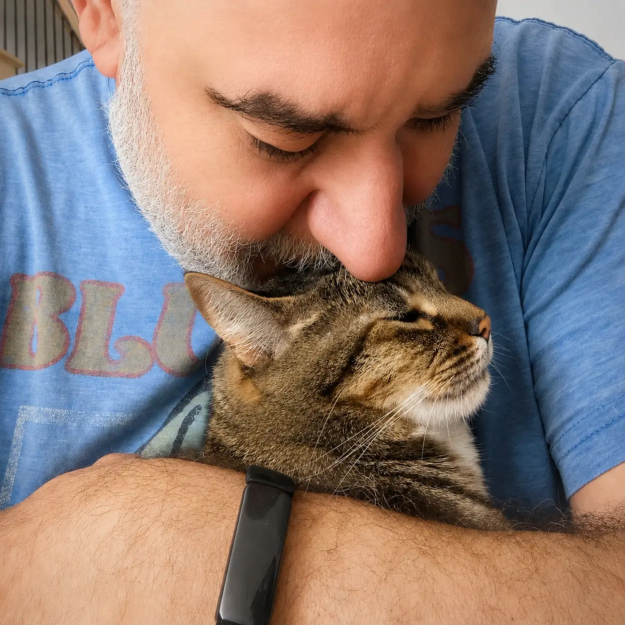 Cat Sitter holding a client cat close in a snuggle.